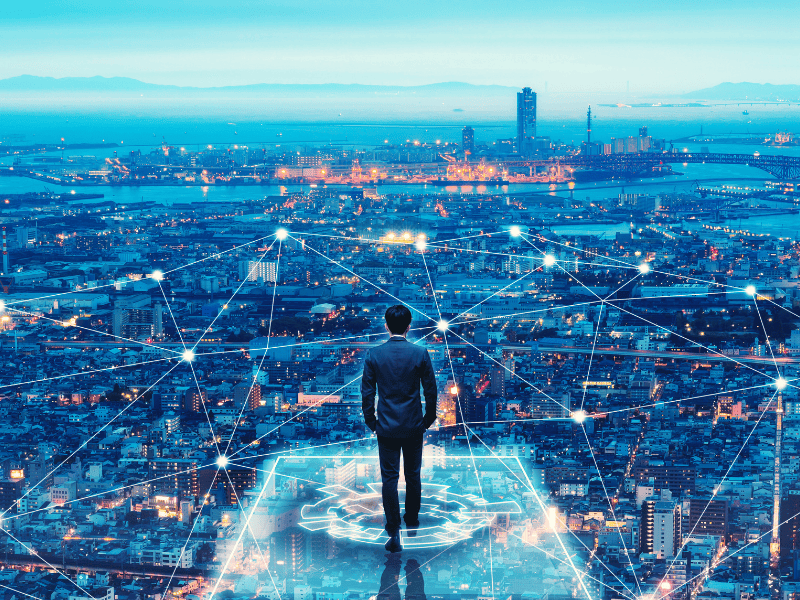 A business man surveying a connected city of the future